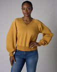 Be unforgettable in the elegant 'Marigold' Zipper Back V-Neck Sweatshirt.