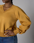 Be unforgettable in the elegant 'Marigold' Zipper Back V-Neck Sweatshirt.