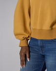 Be unforgettable in the elegant 'Marigold' Zipper Back V-Neck Sweatshirt.