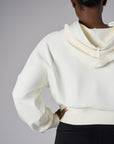 Add a pop of color to your look with the 'Ivory' Cropped Hoodie Sweatshirt.