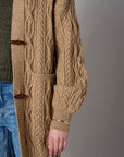 Brown cardigan with denim collar and button front closure.