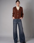 brown cardigan with contrast whipstitch trim and button front closure.