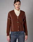 brown cardigan with contrast whipstitch trim and button front closure.