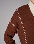 brown cardigan with contrast whipstitch trim and button front closure.