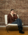 brown cardigan with contrast whipstitch trim and button front closure.
