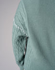 Seafoam cardigan with contrast whipstitch trim and button front closure.