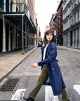 Indigo denim trench coat with a belted waist.