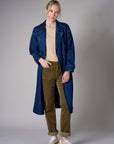 Indigo denim trench coat with a belted waist.