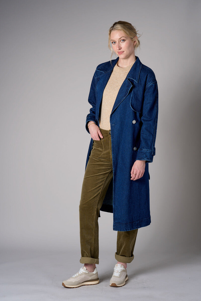 Indigo denim trench coat with a belted waist.