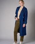 Indigo denim trench coat with a belted waist.