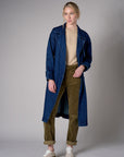 Indigo denim trench coat with a belted waist.