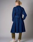 Indigo denim trench coat with a belted waist.