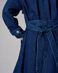 Indigo denim trench coat with a belted waist.
