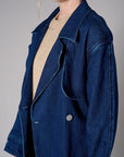 Indigo denim trench coat with a belted waist.