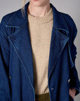 Indigo denim trench coat with a belted waist.