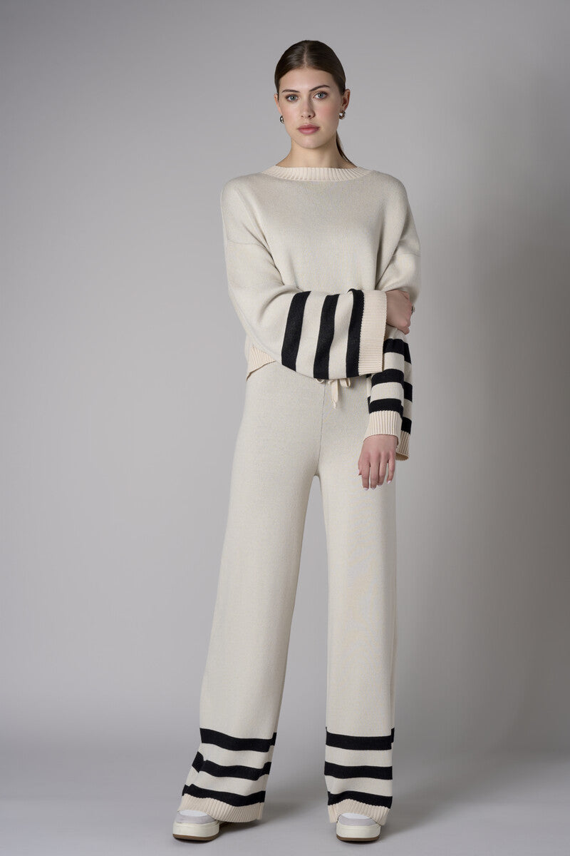 Step up your look with this unique 'Sand' Striped Leg Pant.