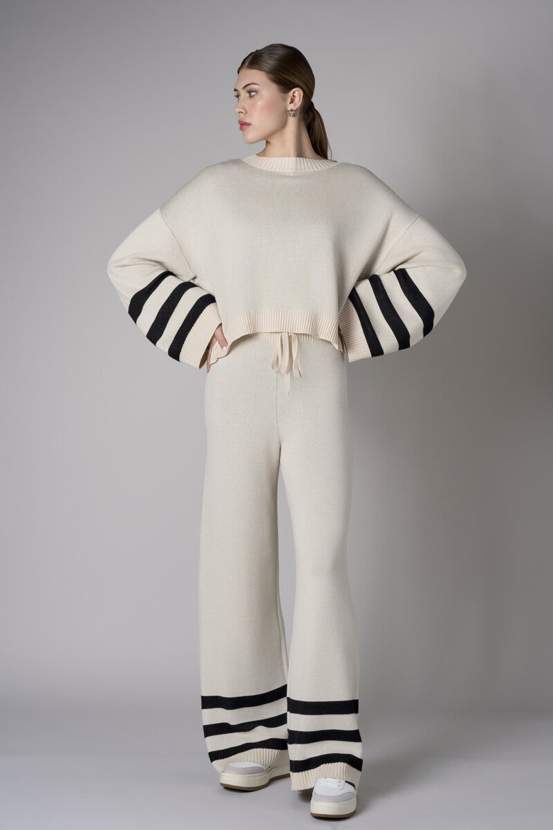 Step up your look with this unique 'Sand' Striped Leg Pant.