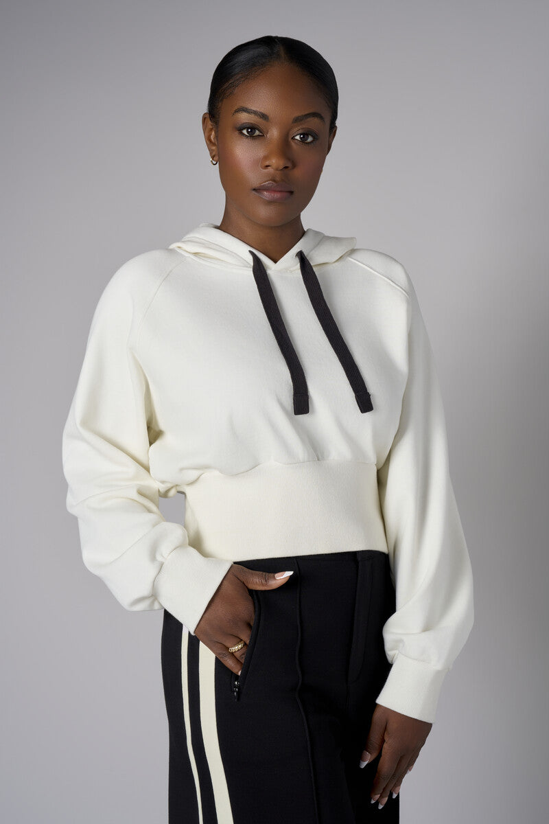 Add a pop of color to your look with the 'Ivory' Cropped Hoodie Sweatshirt.