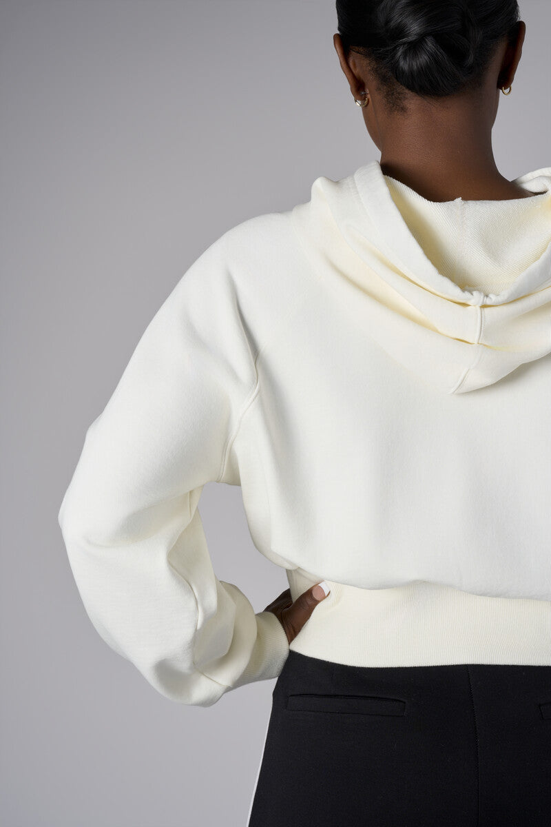 Add a pop of color to your look with the 'Ivory' Cropped Hoodie Sweatshirt.