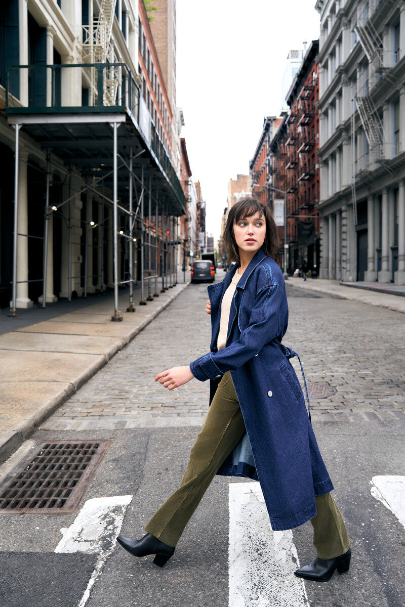 Indigo denim trench coat with a belted waist.