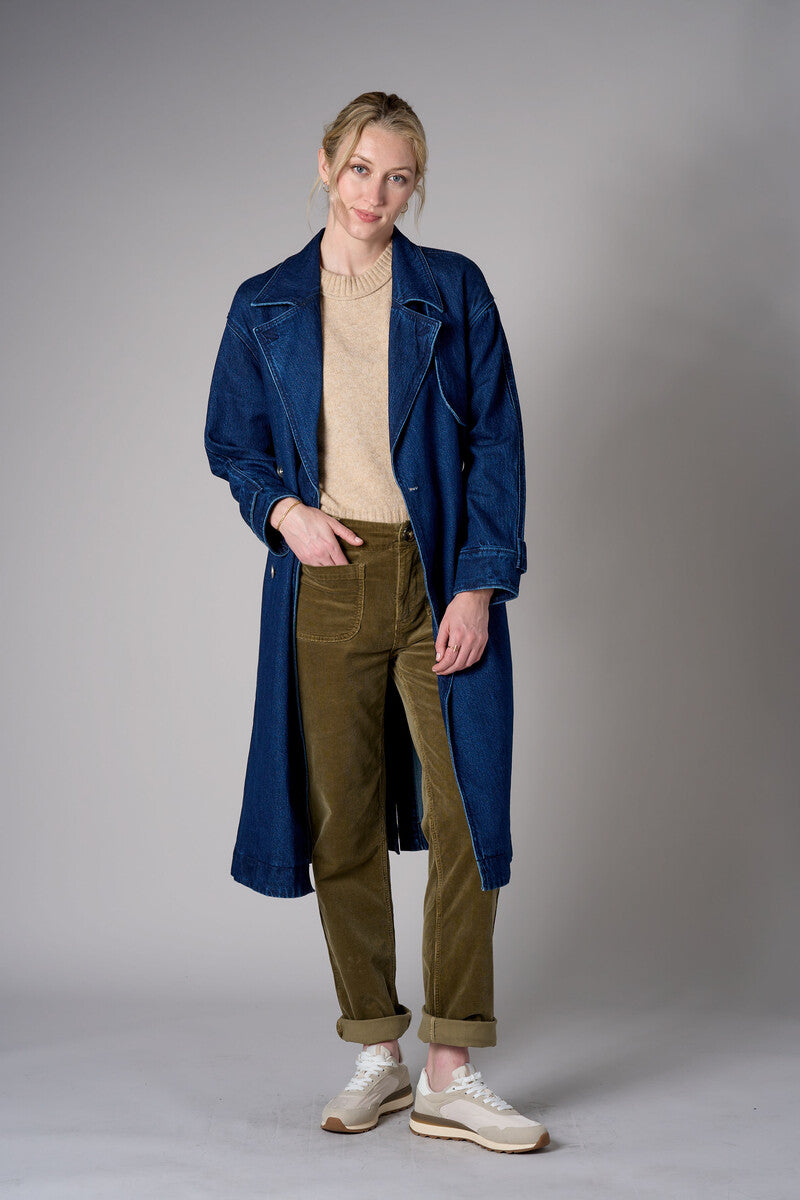 Indigo denim trench coat with a belted waist.