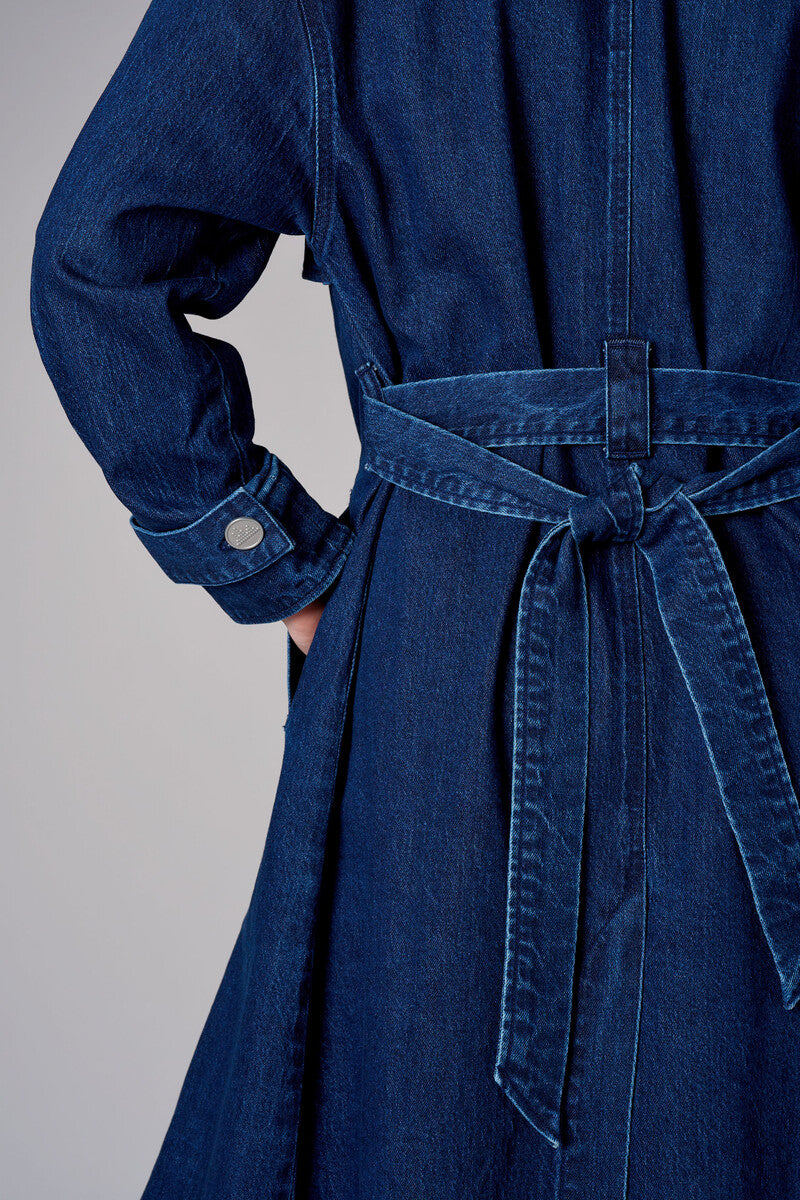 Indigo denim trench coat with a belted waist.