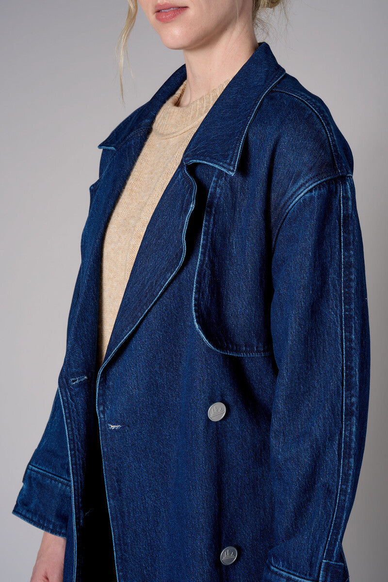 Indigo denim trench coat with a belted waist.