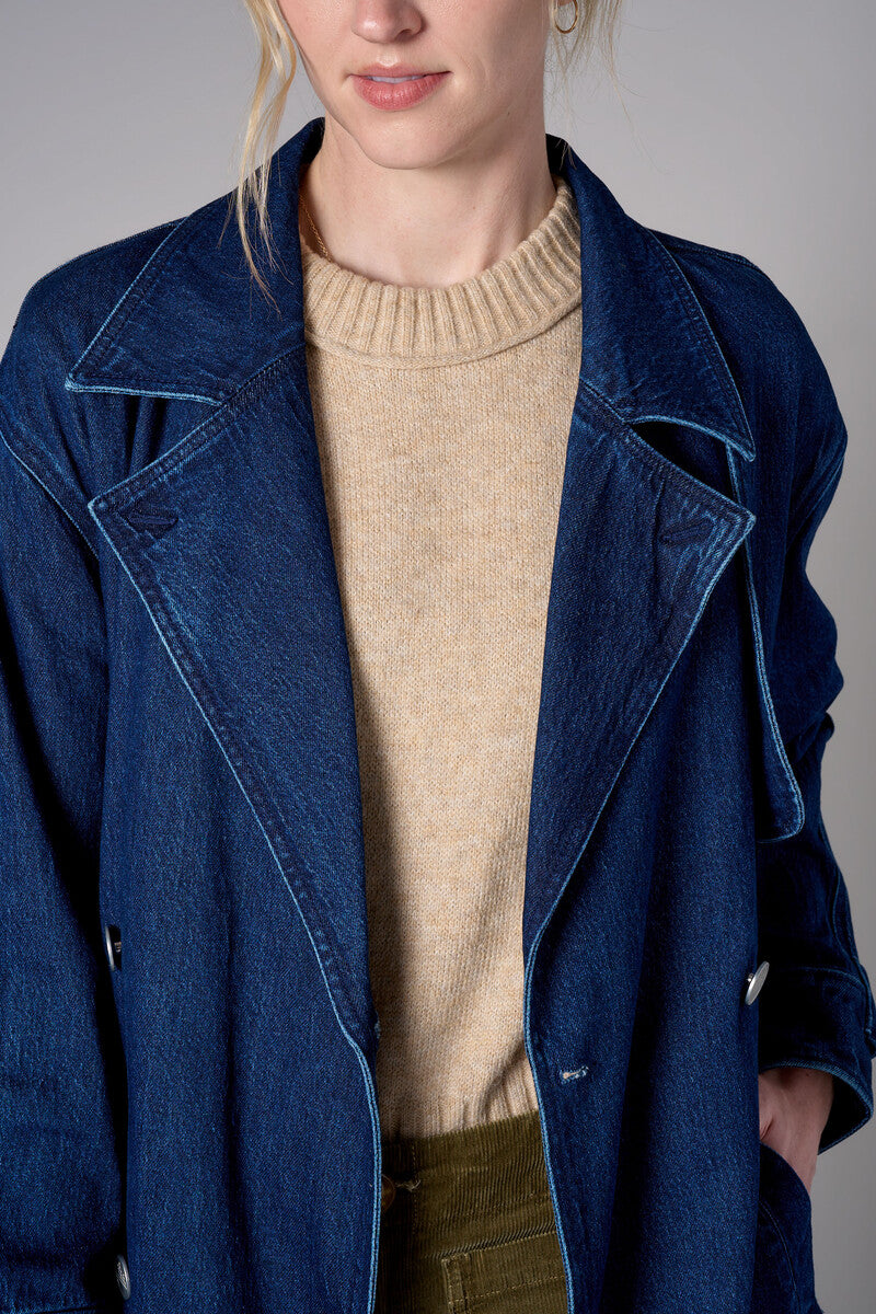Indigo denim trench coat with a belted waist.